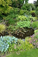 Small round pond with marginal planting - Jardin de Maggy, Centre-Val de Loire, France