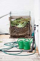 Watering cans and hose. Rooftop kitchen garden in the centre of Rotterdam, Holland.