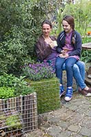 Woman and child admiring gabion containers