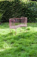 Metal seat in the Orchard. Hill House, Glascoed, Monmouthshire, Wales. 