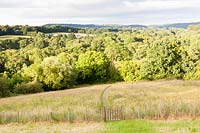 View from the garden: mown path through meadow. Hill House, Glascoed, Monmouthshire, Wales. 