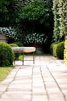 White and green themed garden with seat. La Limonaia Garden. Designed by Arabella Lennox Boyd. Fiesole. Florence. Italy