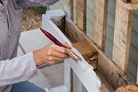 Woman painting pallet with white paint