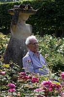 David Austin sitting in his rose garden