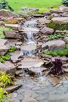 Waterfall. Naturalistic Water Garden - Jackie Knight's Just Add Water - RHS Chatsworth Flower Show 2017  Designer: Jackie Sutton - Built and sponsored by Jackie Knight Landscapes