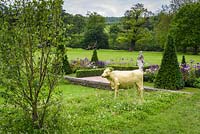 Formal clipped topiary and hand-painted golden Model Cow - Experience Peak District and Derbyshire Garden - RHS Chatsworth Flower Show 2017 - Designer: Lee Bestall MSGD - Builder: JPH Landscapes