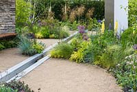 Dry stone walling, wooden bench seat, water feature rill channel and beds of herbaceous perennials, shrubs and trees - Cruse Bereavement Care: 'A Time for Everything' - RHS Chatsworth Flower Show 2017 - Designer: Neil Sutcliffe - Sponsor: London Stone