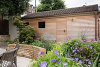 Cedar panelling covering garage with copper drainpipes and light fittings