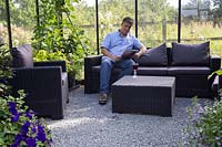 Man relaxing in modern greenhouse