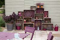 Vintage wooden crate storage with wooden garden table and chairs