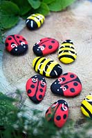 Garden craft making painted Bumble bees and Ladybirds with stones.  Finished Ladybirds and Bumble bees