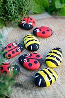Garden craft making painted Bumble bees and Ladybirds with stones.  Finished Ladybirds and Bumble bees