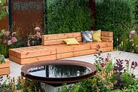 Planting of Agastache 'Kudo Gold', Alchemilla mollis, Hydrangea arborescens 'Annabelle', Penstemon, Pennisetum thunbergii 'Red Buttons', Cotinus and Hart's Tongue Ferns and circular dish pond made of rusty metal. A Place to Meet' Garden. Hampton Court Flower Show, 2017 - Designer: The Association of Professional Landscapers