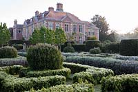 Formal garden planted with box, lavender, laurels and yew at Heale House, Middle Woodford, Wiltshire