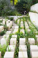 The M and G Garden, view of pillars made of Maltese lime stone, surrounded by Euphorbia melitensis, Salsola melitensis, Limonium melitense, Matthiola incana subsp. melitensis - RHS Chelsea Flower Show 2017