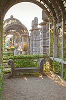 Wooden seat and Pergola in the Collector Earl's Garden at Arundel Castle, Sussex in spring. Head Gardener: Martin Duncan