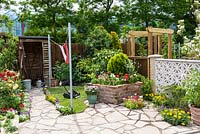 Garden with wooden shed and brick raised bed - BBC Gardener's World Live, Birmingham 2017 - The Anniversary Garden: A Brief History of Modern Gardens - Designer: Prof. David Stevens