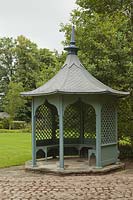 Aqua painted gazebo on lawn with trees - June, Cheshire