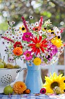 Jug of flowers and fruits in autumn, October.