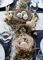 Table set for Easter with eggs and rabbit ornaments