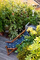 Deckchair on roof terrace, Milan. Italy, May. 