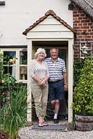 Les and Lynn Mann standing in the doorway of their seventeenth century cottage.