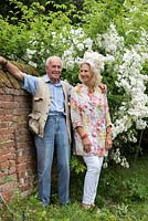 The late Major Iain Grahame with his wife, Bunny Campione, beside Rosa 'Rambling Rector' in their country garden at Daws Hall, Suffolk.