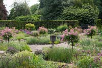 Sylvia's Garden at Newby Hall, a sunken, formal layout of beds with Byzantine stone corngrinder, July. 