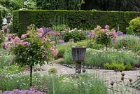 Sylvia's Garden at Newby Hall, a sunken, formal layout of beds with Byzantine stone corngrinder, July.
