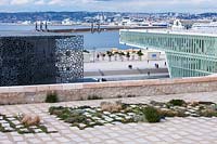 Planted stone slabs and view from the Jardin de Migrations, Saint Jean, Marseilles, France, February.