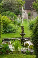 Tiered stone fountain with Iris, Oxfordshire, June.