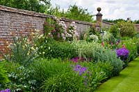 Border in the walled garden with Peonies, Tradescantia, Clematis, Roses, Geraniums