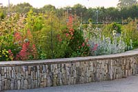 Limestone wall with border of Stachys byzantina 'Silver Carpet', Alliums, Fennel and Achillea 'Moonshine'