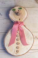 Completed Birch wood snowman on workbench