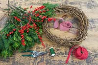Materials and tools required to construct a festive Christmas wreath