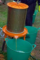 Hydropress pressing system that uses mains water pressure to extract high levels of juice from milled apples and pears in use at Community apple juicing day in Sampford Peverell, Devon, late October