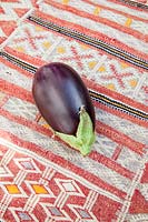 Aubergine on a kilim covered table