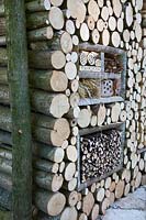 Insect hotel set in a log wall