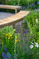 Contemporary garden with curved wooden benches. Designers Catherine Chenery Barbara Harfleet