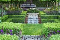 Stone paths, box hedges and sunken lawn in Support, The Husqvarna Garden. Designer: Charlie Albone. RHS Chelsea Flower Show