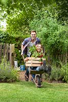 Young couple with wheel barrow