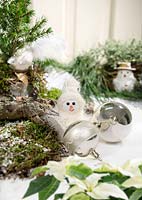 Christmas arrangement with snowman an Christmas ornaments