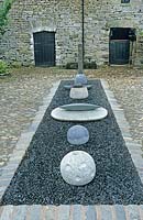 Granite stone sculpture installation in country courtyard