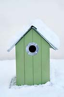 Bird house covered with snow