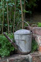 Old watering can on brick wall The Old Gate RHS Chelsea 2007