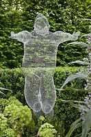 RHS Chelsea Flower Show 2013. The Arthritis Research UK Garden by Chris Beardshaw wire mesh figurative sculpture