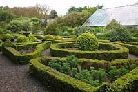 Pond, fountain, box hedges and topiary in the Elizabethen Knot Garden at Dalemain House & Garden, Cumbria