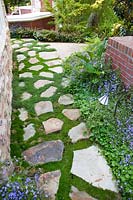 Groundcovers used as natural gap filler, path with natural stone