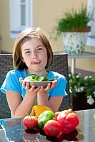 Girl with cucumber slices on a plate