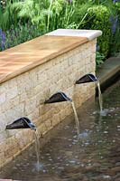 Chelsea Flower Show, 2009. The QVC Garden ( des. Adam Frost ) Water spouts in low wall